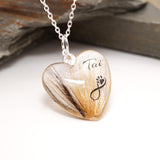 Heart-shaped pendant with fur and infinity paw print symbol